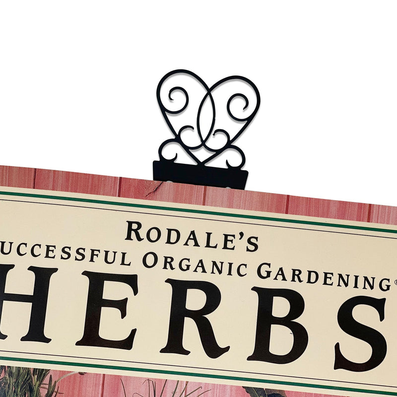 Victorian Heart Bookmark -Flat Black clipped to a book, showcasing its elegant heart-shaped top. Perfect for decorative and functional book organization.