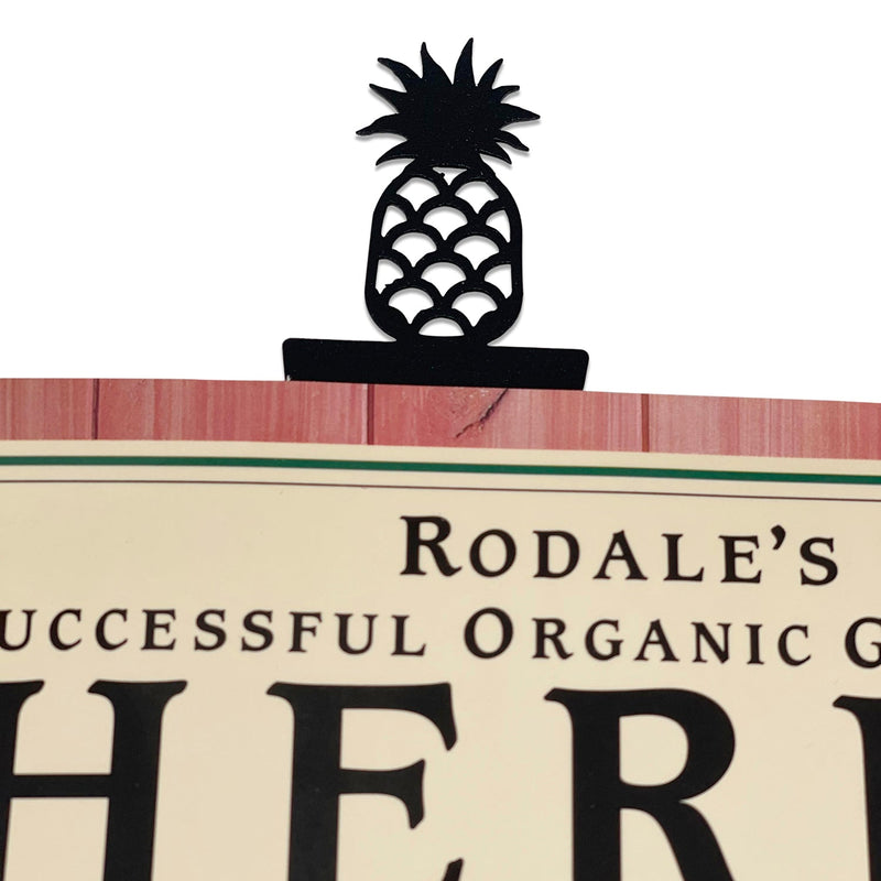 Pineapple Bookmark -Textured clipped onto a book page, showcasing its decorative top and sturdy design for book lovers and office accessories.