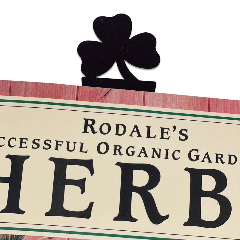 Shamrock Bookmark -Bronze peeking from the top of a book, showcasing its decorative clover design and sturdy clip for secure page marking.