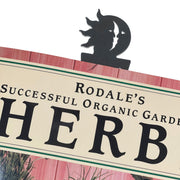 Textured Sun & Moon Bookmark clipped onto a book, showcasing its celestial design and sturdy functionality for book lovers.