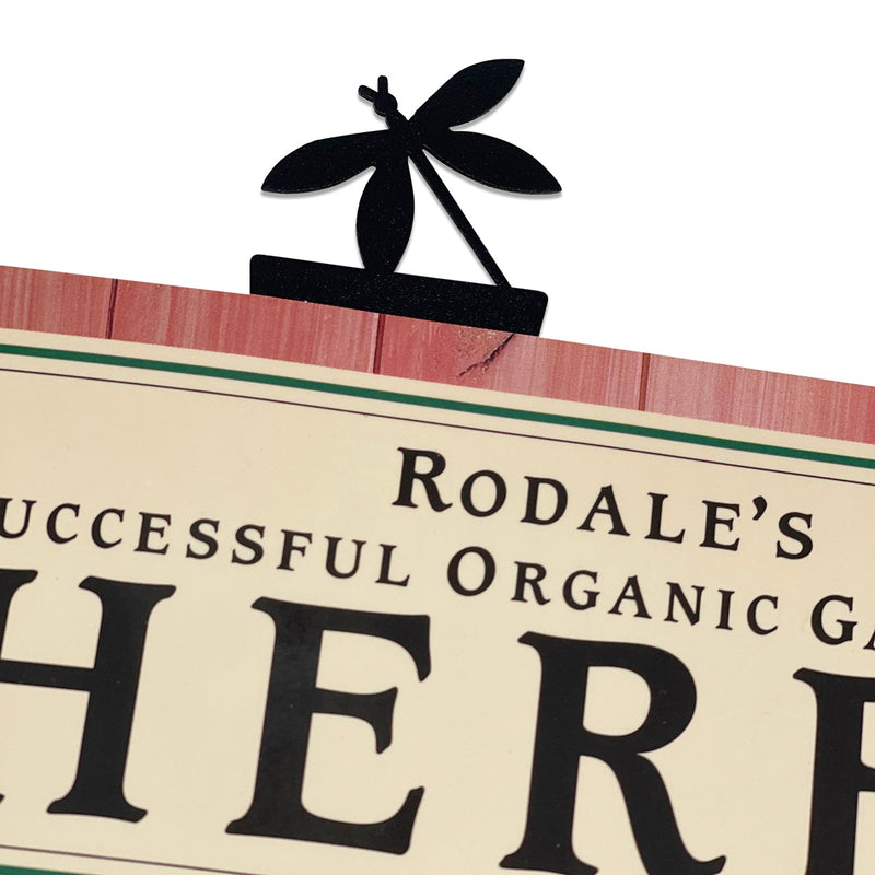 Dragonfly Bookmark -Textured clipped onto a book page, showcasing its decorative dragonfly top and sturdy metal construction for office or home use.