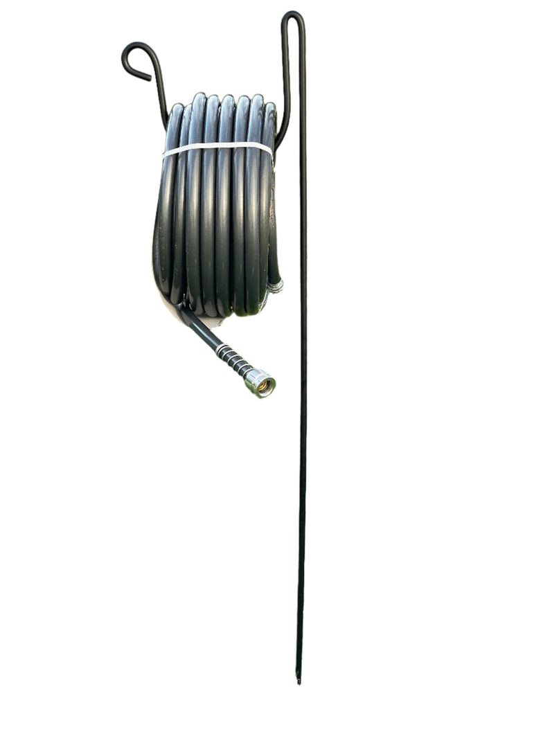 Hose Holder Round Large with black garden hose coiled neatly, ideal for outdoor hose organization and storage in lawns or gardens.