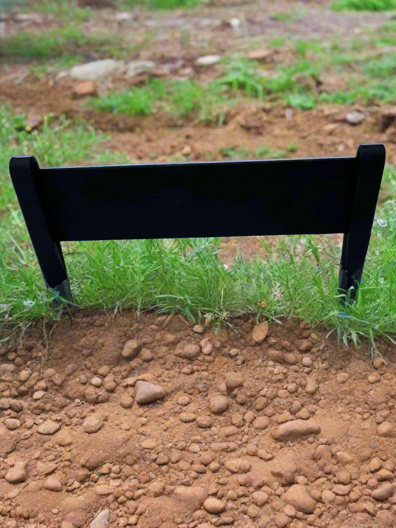 Outdoor Boot Scraper installed in soil with grass, designed for scraping mud and debris off shoes in garden or yard settings.