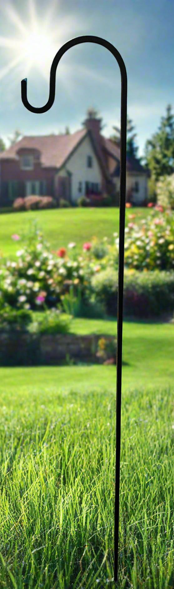 56"H Lawn Hook - 3/8" Solid Square Iron staked in lawn with scenic garden background, ideal for hanging baskets or lanterns.
