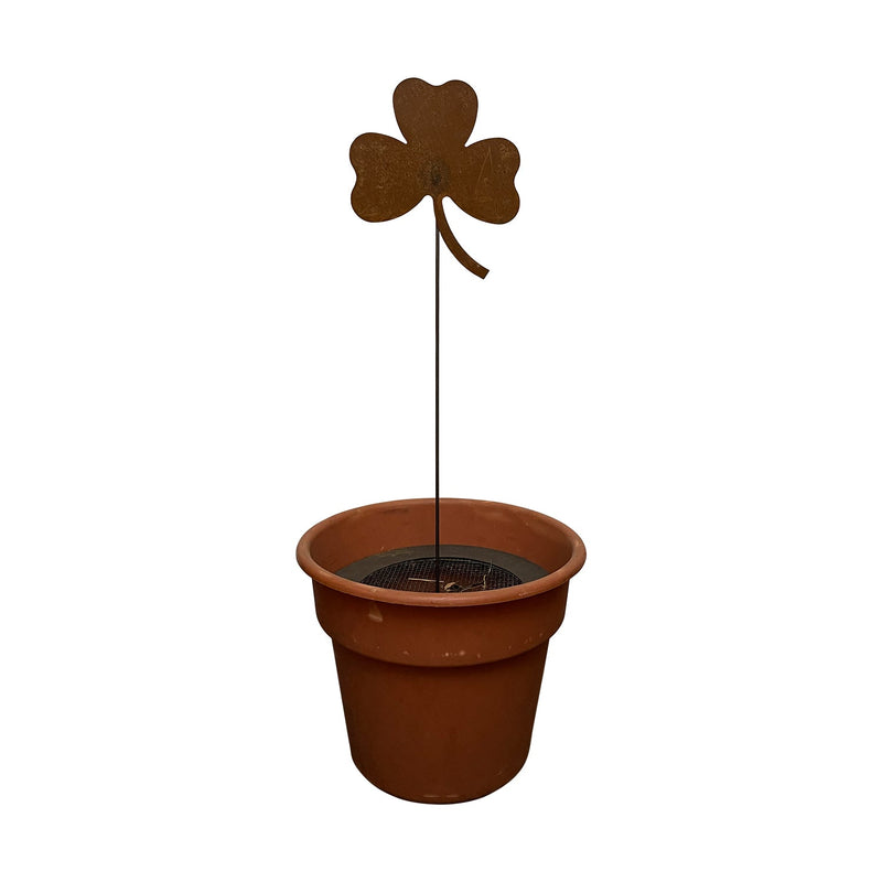 Shamrock Rusted Garden Stake displayed in a terracotta pot, perfect for adding festive flair to patios or garden planters.