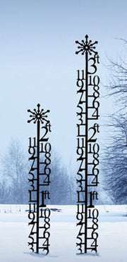 Two 2 Foot Snowflake Snow Gauges displayed in snowy outdoor setting. Great for tracking snowfall and enhancing seasonal garden decor.