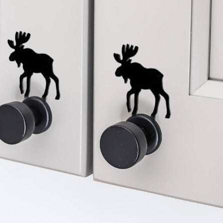 Black moose silhouette cabinet knob accents on light gray cabinet doors, offering a unique decorative hardware solution.