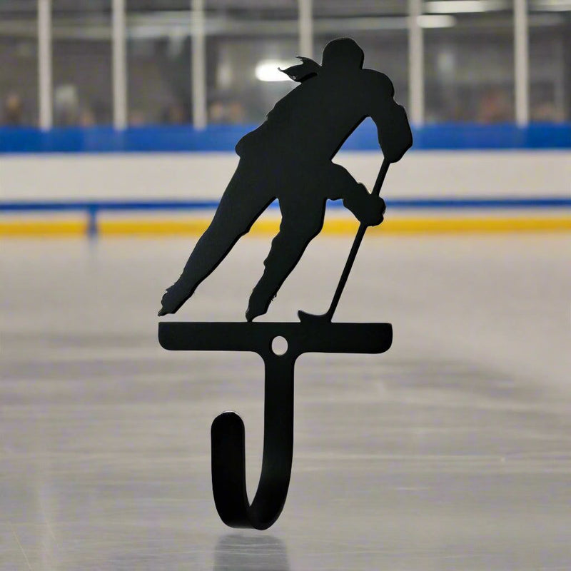 Hockey Player Woman Girl Wall Hook Small displayed on an ice rink background, perfect for utility storage in sports-inspired spaces.