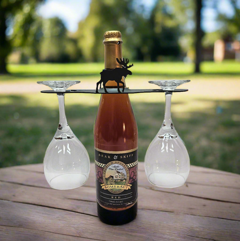 Outdoor setup of Moose Wine Caddy - Wine Caddy for Two Glasses holding wine and glasses, perfect for picnics or rustic-themed gatherings.
