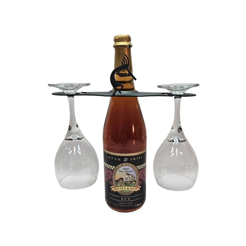 Kokopelli Wine Caddy holding a wine bottle and two glasses, ideal for festive wine presentation and storage in home bar furniture settings.