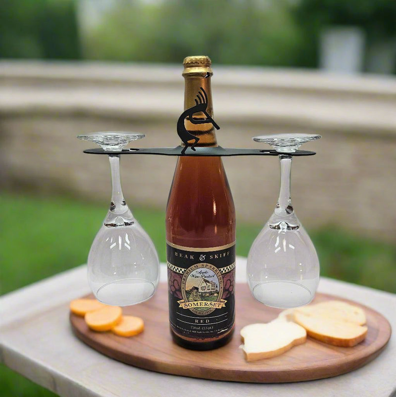 Kokopelli Wine Caddy displayed outdoors on a wooden tray with wine and snacks, perfect for holiday entertaining and wine rack decor.
