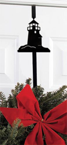 Lighthouse Door Wreath Hanger displayed on a white door holding a festive wreath with a red bow, perfect for nautical holiday decor.