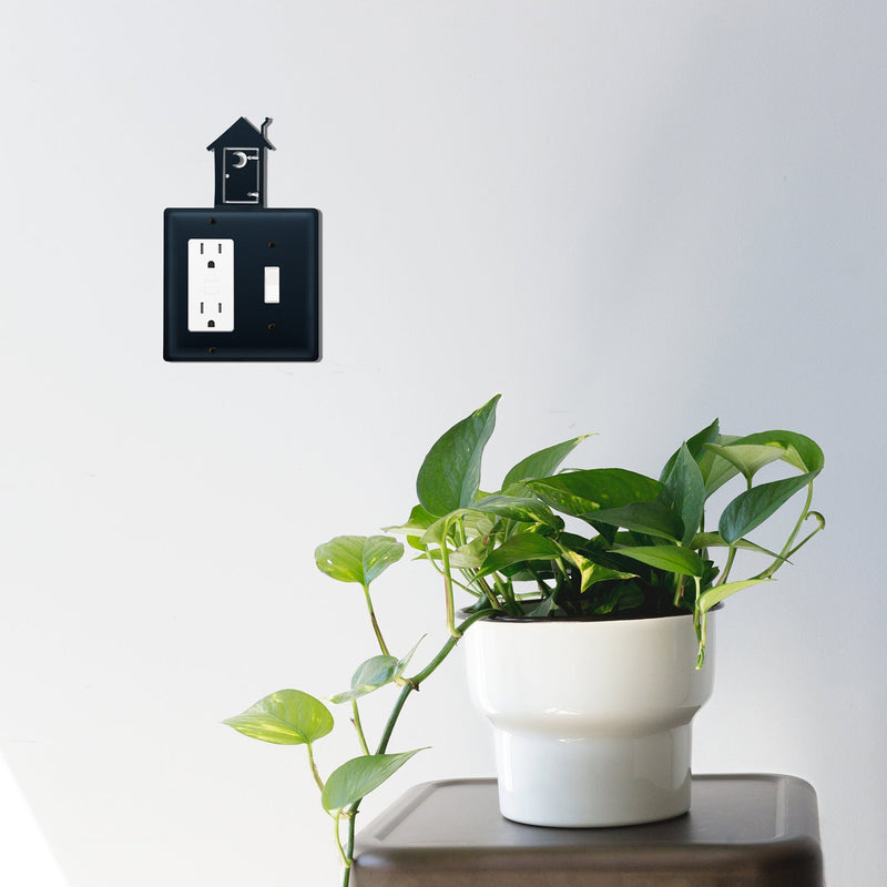 Installed Double Outhouse Single GFI and Switch Cover CUSTOM Product on wall, blending with modern decor and indoor plants for a farmhouse touch.