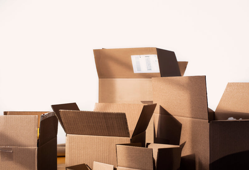 Multiple large cardboard boxes open and stacked, representing Carrier's additional handling for dimensional weight $20 (large package)-DO NOT REMOVE.