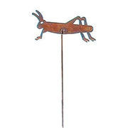Close-up of rusted metal garden stake featuring a grasshopper design. Adds vintage charm to lawn ornaments and garden sculptures.