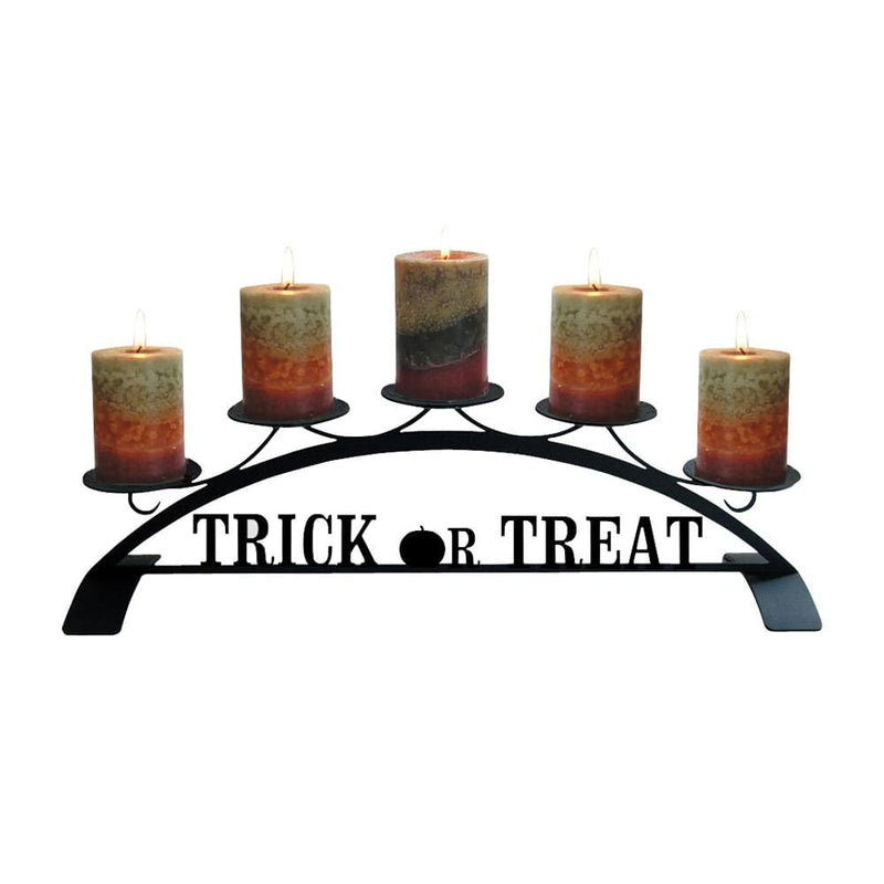 Trick Or Treat Table Top Pillar Candle Holder with five lit autumn-themed pillar candles on a black metal stand, perfect for Halloween decor.